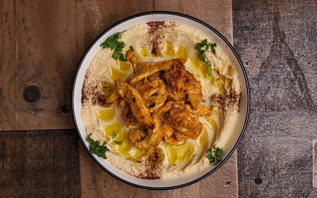 Classic hummus topped with sliced shawarma